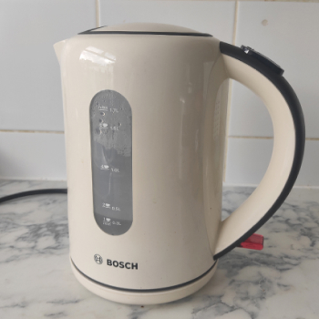 An electric kettle placed on a tile